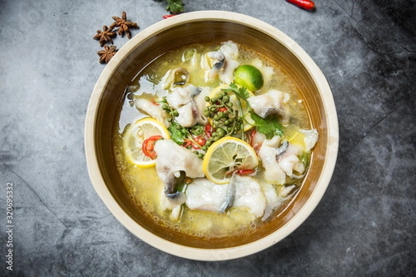 Fototapeta This is a famous dish in chengdu, sichuan province, China. It is called clear sweet sour and hot fish. It is mainly made of lemon, pepper, grass carp, green pepper and chicken soup