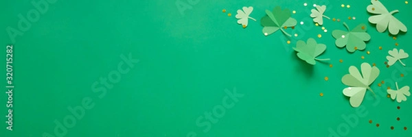 Fototapeta St. Patrick's day, clover on a green shiny background