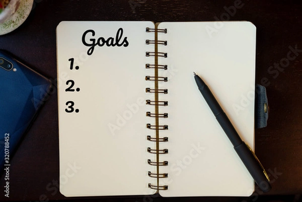 Fototapeta topview goals list on paper, smartphone, pen