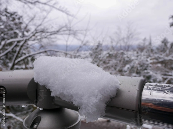 Obraz Snow captured on a stainless steel railing.
