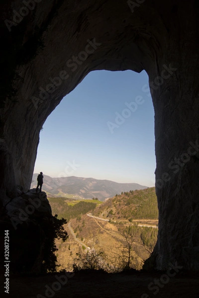 Fototapeta man inside a cave in basque country, spain