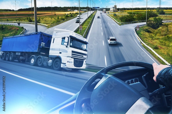 Fototapeta Abstract background with a truck, truck steering wheel and a road with cars and a sky with blue lights