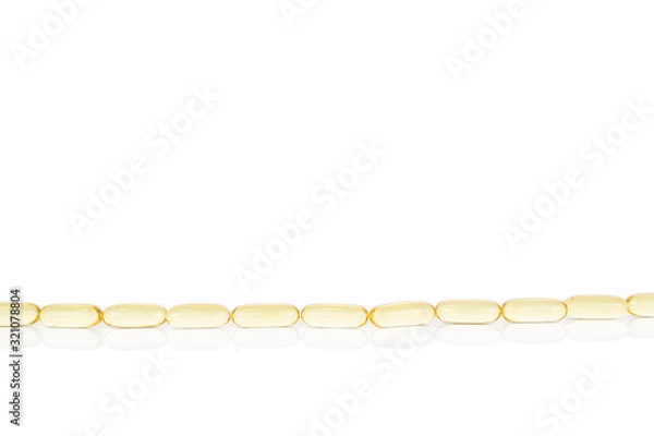 Fototapeta Lot of whole golden fish oil in row isolated on white background
