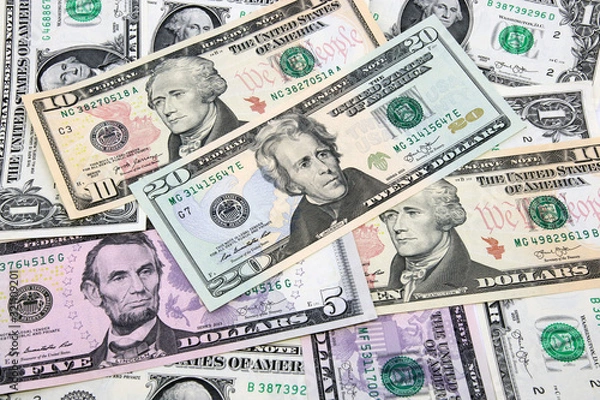 Fototapeta American paper money background. Mix of banknotes in denominations of 1, 5, 10 and 20 dollars. Front side of USA dollars bills with portraits of former presidents.