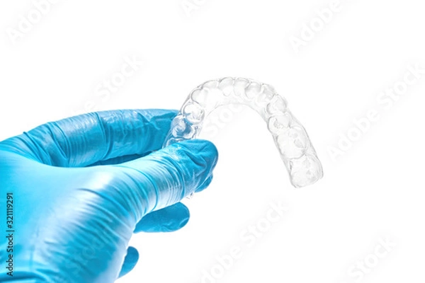 Fototapeta Hand holding individual dental tray for bleaching teeth