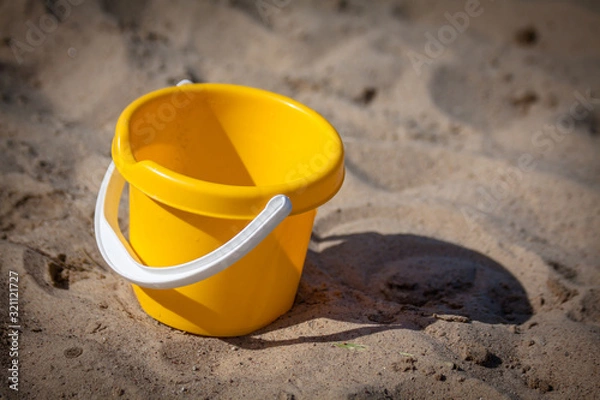 Obraz yellow bucket on the beach