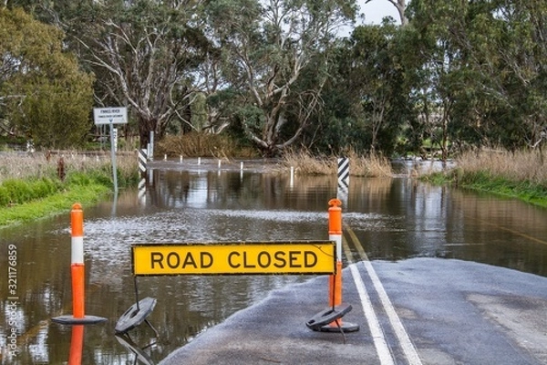 Fototapeta Road closed due to flooding showing road closed sign