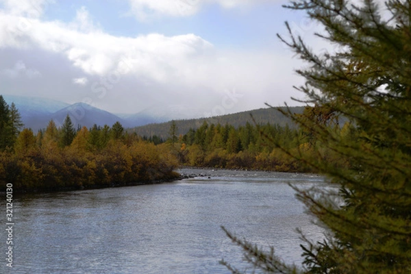 Fototapeta Beautiful landscape of a river flowing among the mountains