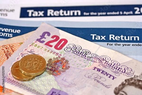 Obraz UK Tax Return documents with £20 and £10 banknotes and coins, symbolising personal taxation, payment to HMRC.