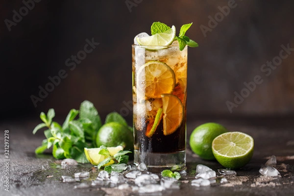 Obraz Cuba Libre with brown rum, cola, mint and lime. Cuba Libre or long island iced tea cocktail with strong drinks