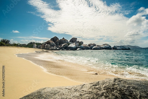 Fototapeta The Baths in Virgin Gorda BVI with rock formations that are beautifully complimented with the blue water surrounding them. 