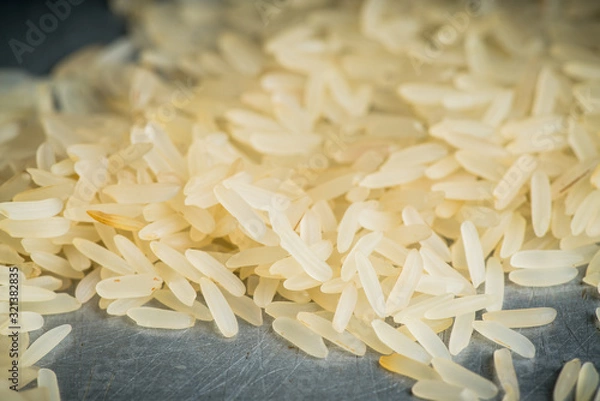 Obraz Raw rice on the kitchen table. Selective focus. shallow depth of field.