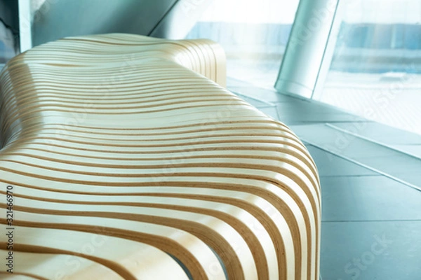 Fototapeta A curved wooden bench in a perspective. Modern bench in a business centre.