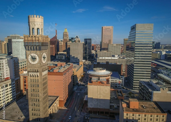 Fototapeta Aerial View of Downtown Baltimore Maryland on a Sunny Fall Afternoon - with the Seltzer Arts Clock Tower and Various Buildings and Skyscrapers in the Frame