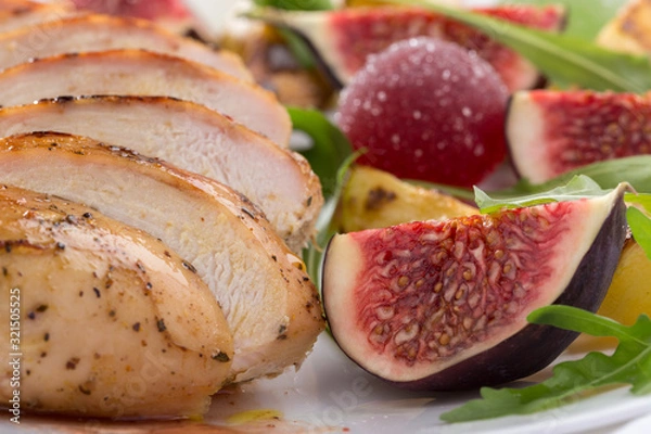 Obraz Baked chicken with fig and arugula salad. Chicken breast, fig, arugula. Dinner. Fried chicken breast with vegetables and figs. Dish with figs. fried chicken with figs and onions. Free space for text. 