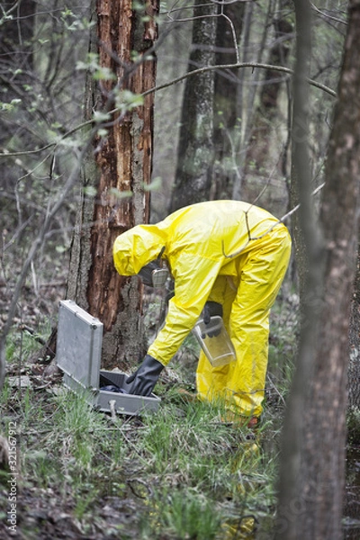 Fototapeta professional in protective coveralls preparing to taking sample  to container in  contaminated area