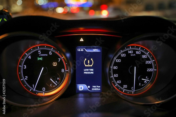 Fototapeta Low tire pressure error sign. Warning lights flash on the car dashboard. 