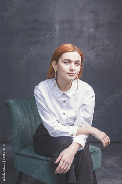 Fototapeta Red-haired girl on a dark background shows different emotions