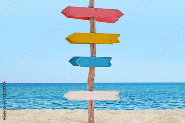 Obraz Signboard with arrows on the beach. 