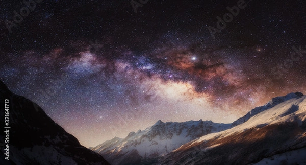 Fototapeta Panorama of night sky full of stars with colorful Milky Way in the mountain. Nepal, Himalayas.