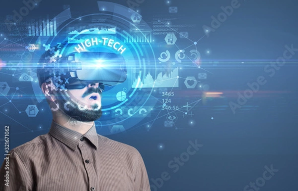Fototapeta Businessman looking through Virtual Reality glasses with HIGH-TECH inscription, innovative technology concept