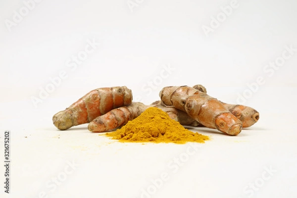 Fototapeta Turmeric powder and turmeric root extract on a white background are used as a tonic for the body and food ingredients.