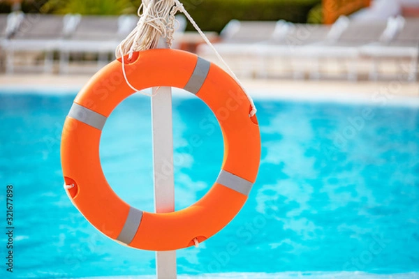 Fototapeta life buoy close-up on pool background with blurry background