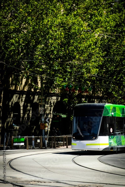 Fototapeta Famous Melbourne city cycle trams with tour groups at Australia