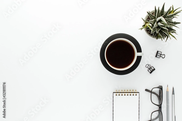 Fototapeta Notepad coffee cub glasses modern business background with copy space for your text. Top view, flat lay.