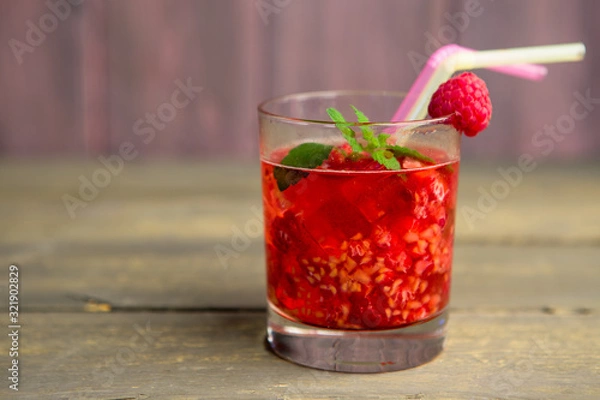 Fototapeta Glass of fresh strawberry smoothie and fresh strawberries on pink wooden background. Healthy food and drink concept.