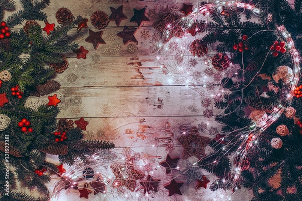 Fototapeta Christmas background with fir twigs, red berries, cones and Xmas decoration.