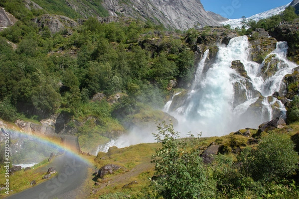 Fototapeta mountainous landscape with a large waterfall and rainbow
