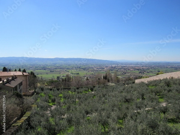Fototapeta View from an overlook at hills, valleys, and towns as seen from Assisi, Italy