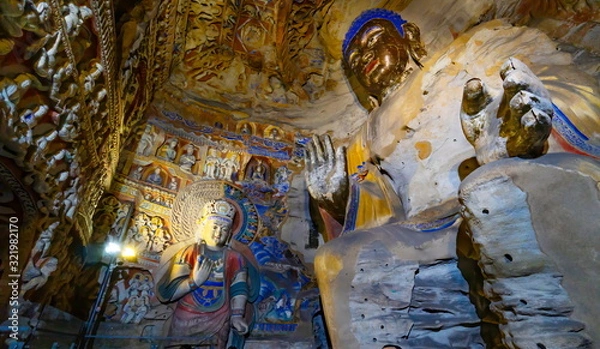 Obraz Old statue inside a cave. Seated buddha in Yungang Grottoes  near Datong, Shanxi Province, China