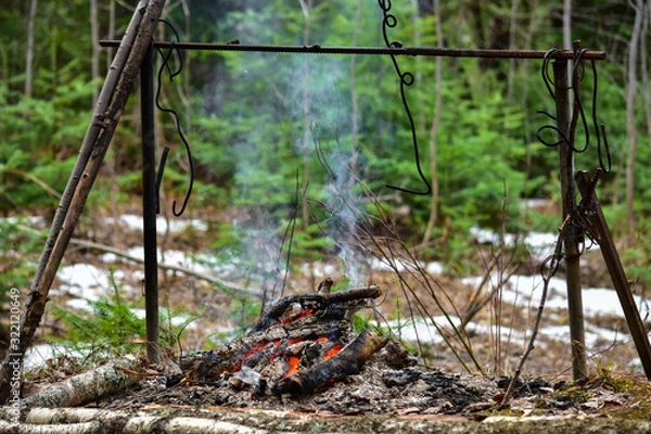 Fototapeta Cooking at the stake, in nature. Universal stand for cooking at the stake.