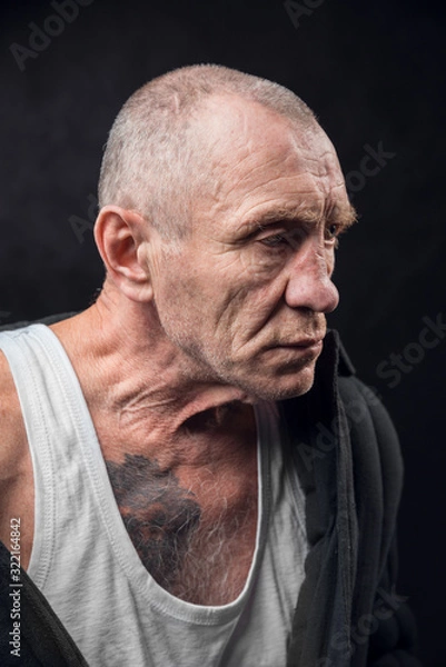 Obraz Closeup portrait of an old man on a black background