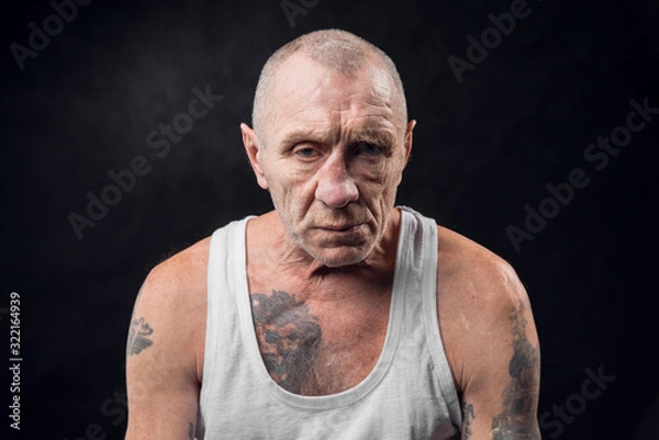 Obraz Portrait of an old alcoholic man on a black background
