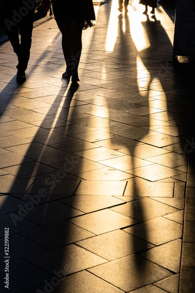 Obraz Long human shadows projected on the pavement at sunset
