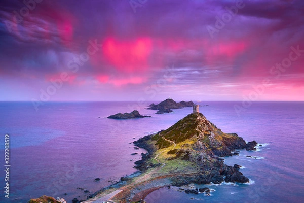 Obraz View of Pointe de la Parata on the west coast of Corsica France Europe. A ruined Genoese tower sits on top of the rocky promontory overlooking the archipelago of the Sanguinaires on the colored sunset