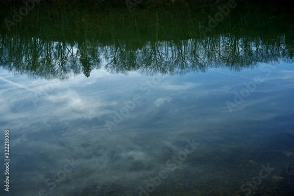 Fototapeta Reflection on lake - upside down trees