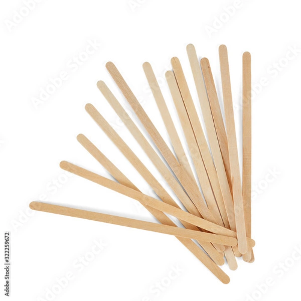 Fototapeta Wooden stirrers for coffee, tea and drinks, laid out in random order, isolated on a white background.