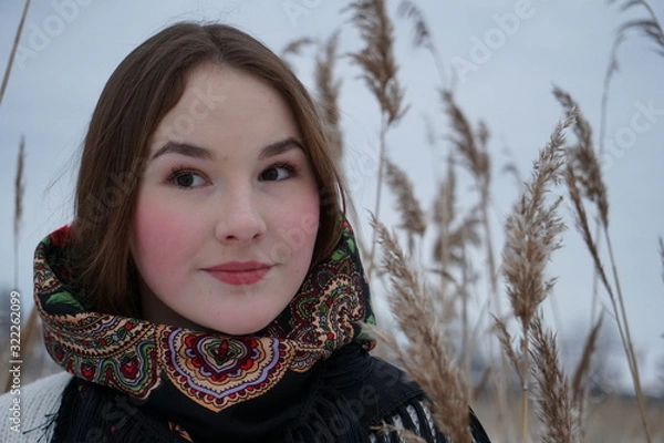 Obraz close-up portrait of a girl in a white sweater and openwork shawl on a background of nature