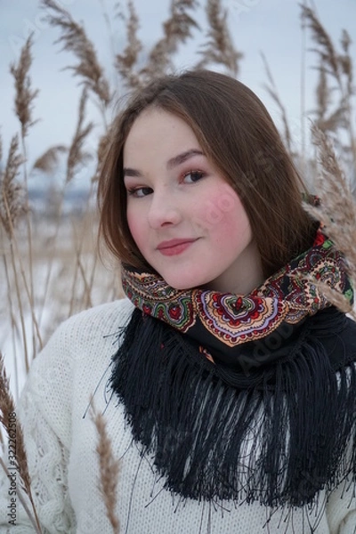 Obraz close-up portrait of a girl in a white sweater and openwork shawl on a background of nature