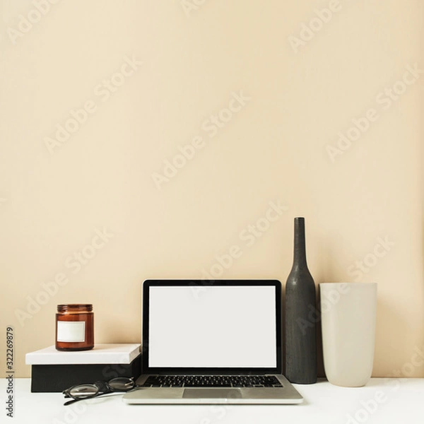 Fototapeta Laptop with mockup blank copy space screen on table. Office desk workspace with decorations. Minimal freelancer co-working concept.