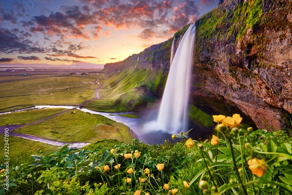 Obraz Incredible sunset on Seljalandsfoss. One of the most beautiful waterfalls on the Iceland, Europe. Popular and famous tourist attraction summer holiday destination in on South Iceland. Travel postcard.