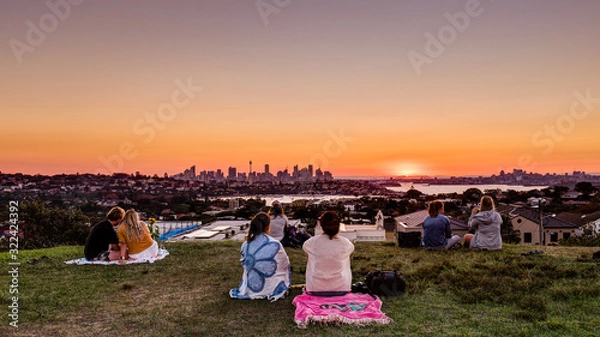 Fototapeta Sydney, NSW / Australia - April 28 2019: A group of community people enjoying the view of sydney on sunsetfrom Dover Height/Caffyn Park