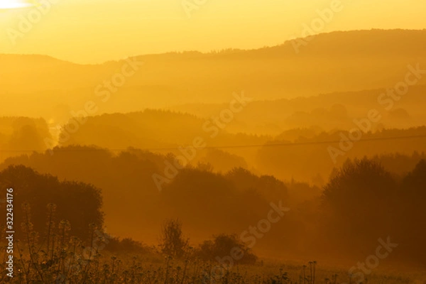 Obraz hazy golden sunrise in the mountains