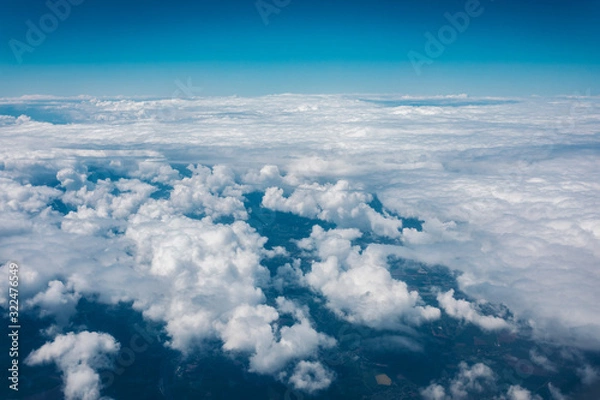 Fototapeta Sky with clouds from airplane window during flight.