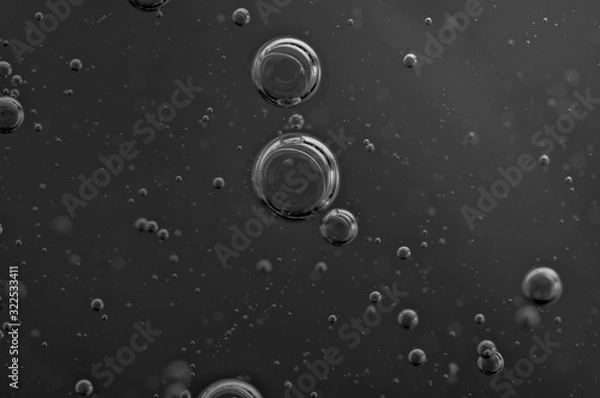 Fototapeta Dark background. Liquid with air bubbles for projects, oil, honey, beer, juice, shampoos. Black and white