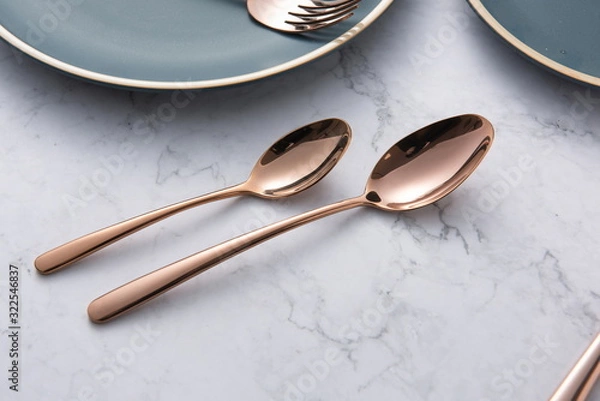 Fototapeta The golden tableware used in the wedding is in the background of marble